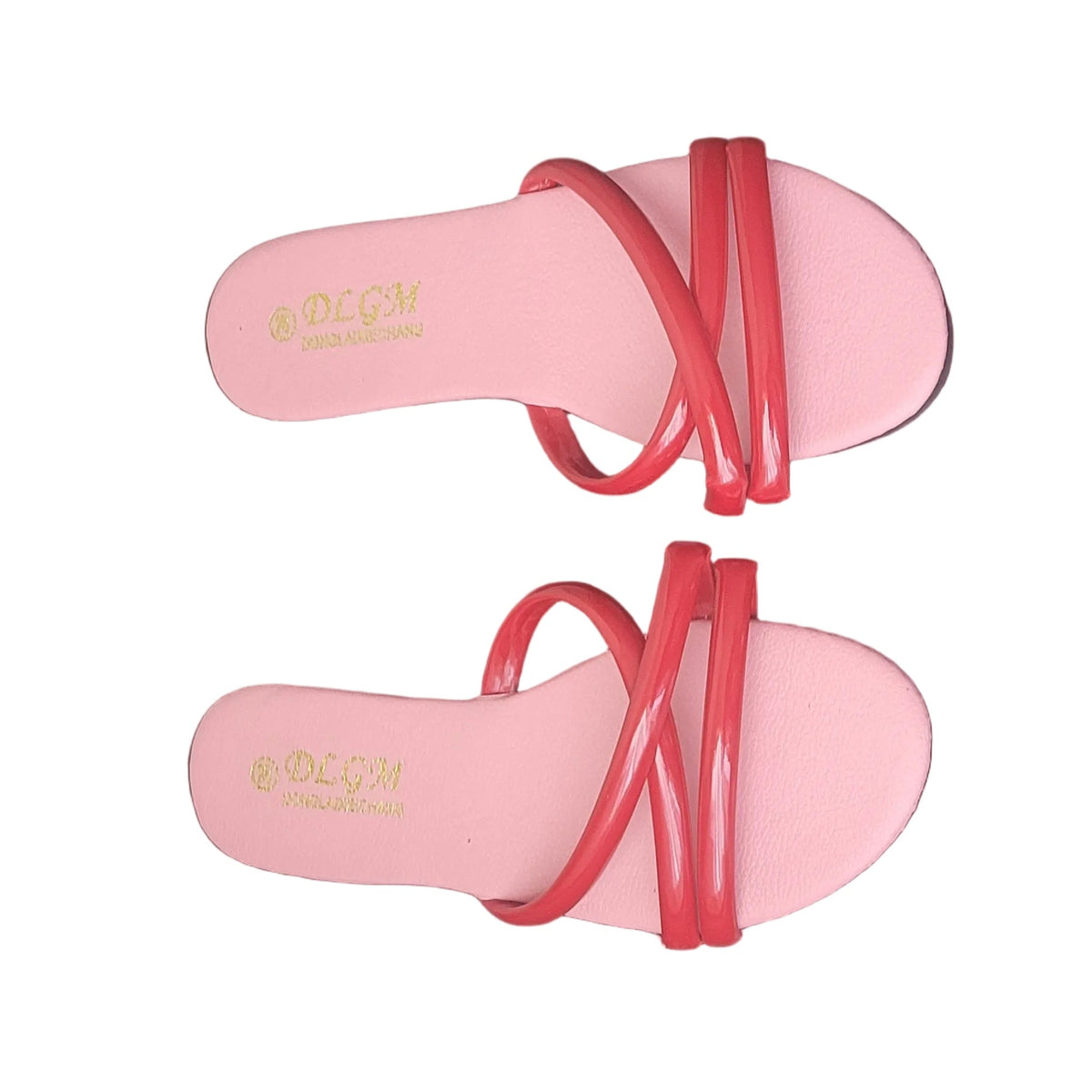 A pair of pink slide sandals with red crisscross straps, placed on a dark brown wooden floor. The brand name 'DEGM' is printed in gold on the insole.