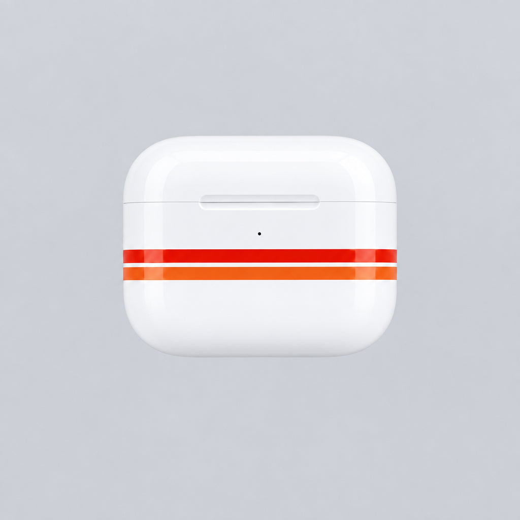 A white wireless earbud charging case with two orange stripes, shown with a white USB-C cable on a white tabletop.
