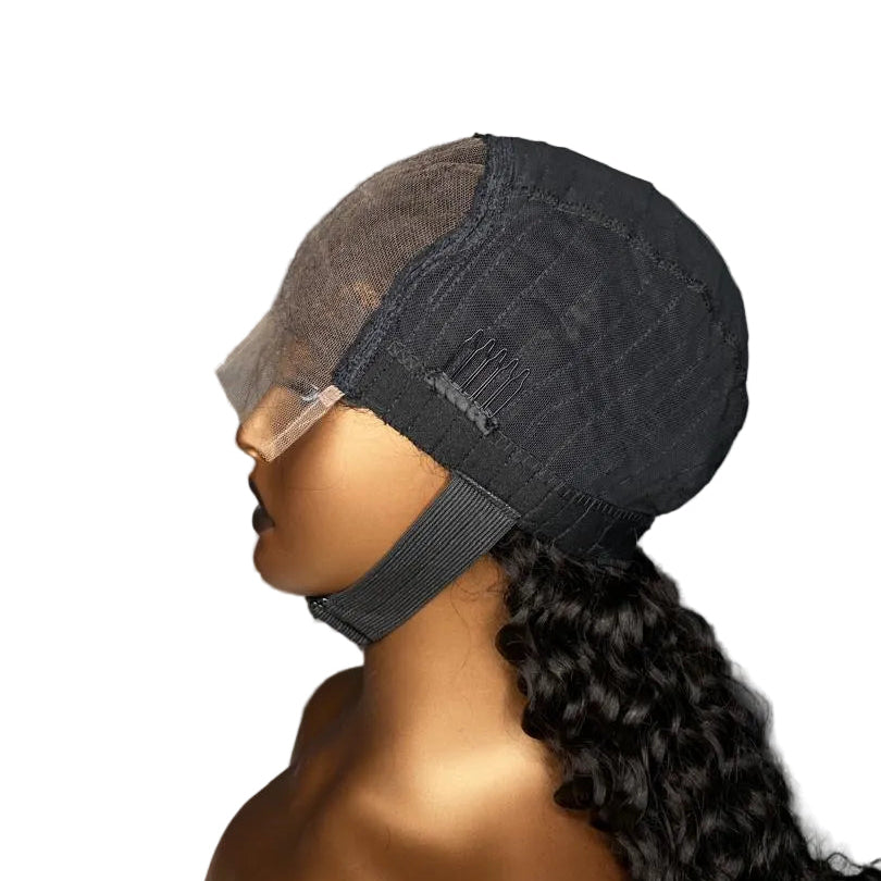 A side-profile view of a mannequin wearing a dark charcoal gray lace front wig with long, curly black hair. The mannequin head is shown against a plain white background.