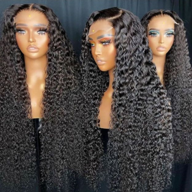 Three mannequin heads wearing long, dark curly wig extensions or full wigs, shown against a dark backdrop. The wigs have deep, glossy black curls with a natural-looking part line on the mannequins.