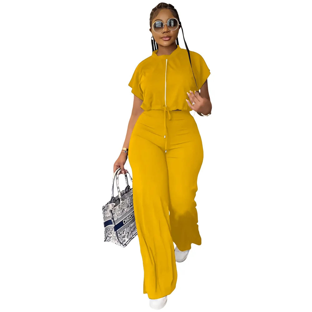 Woman wearing a yellow outfit holding a patterned handbag on a white background