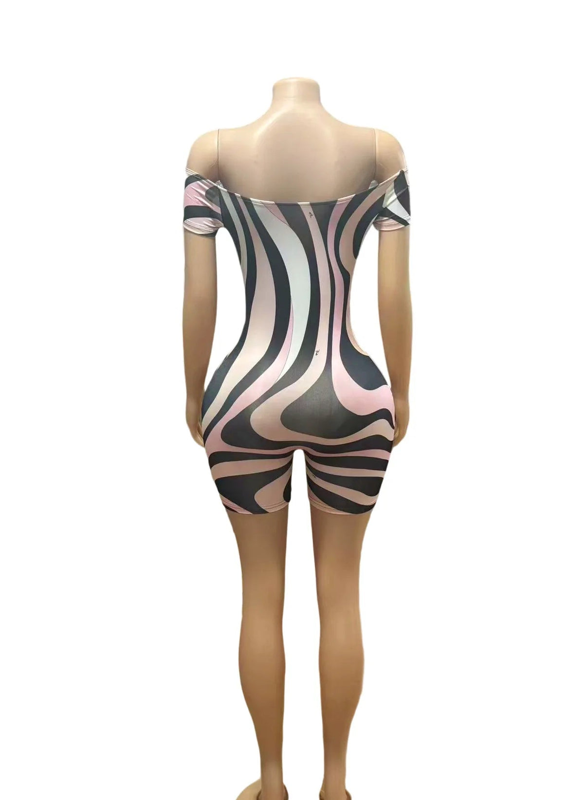 A short off-the-shoulder bodysuit with a wavy abstract pattern in black, pink, and white, displayed on a female mannequin against a white background. The brand name 'CM.