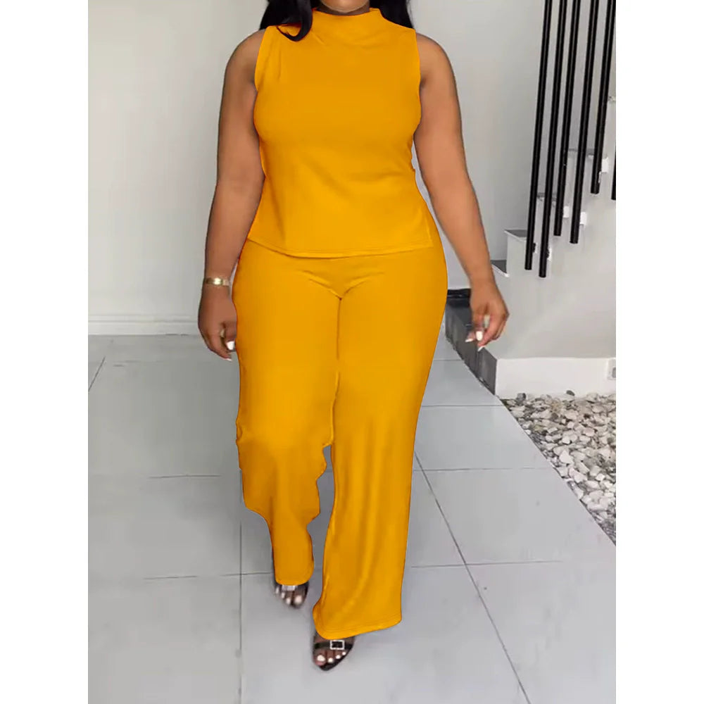 Person wearing a mustard yellow sleeveless top and pants in an indoor setting.