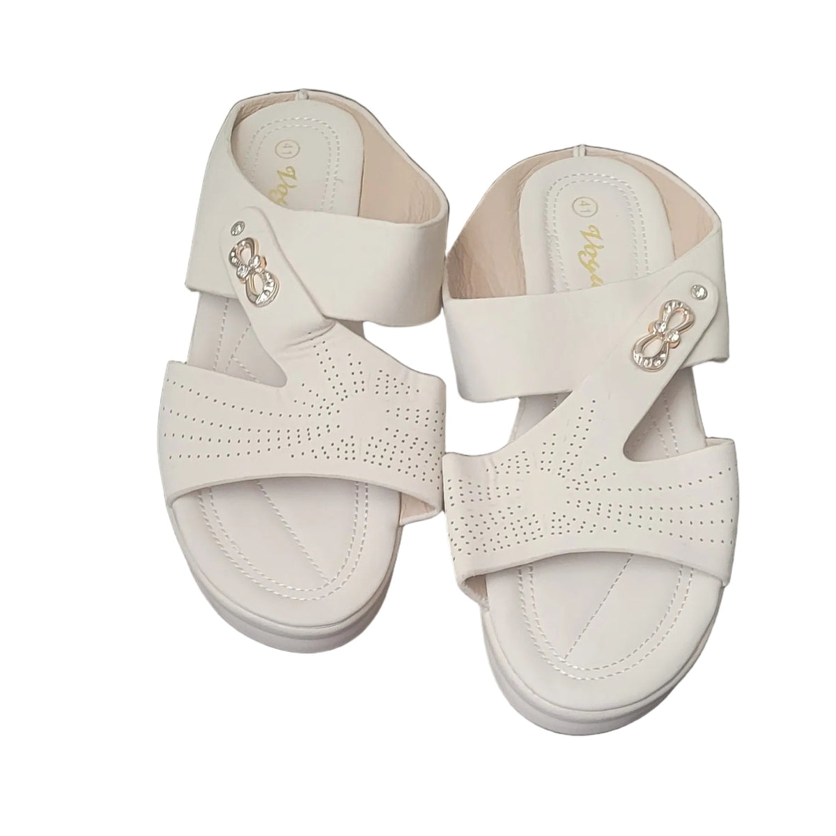 A pair of off-white platform sandals with woven straps and small gold-tone decorative accents, shown on a dark wood floor.