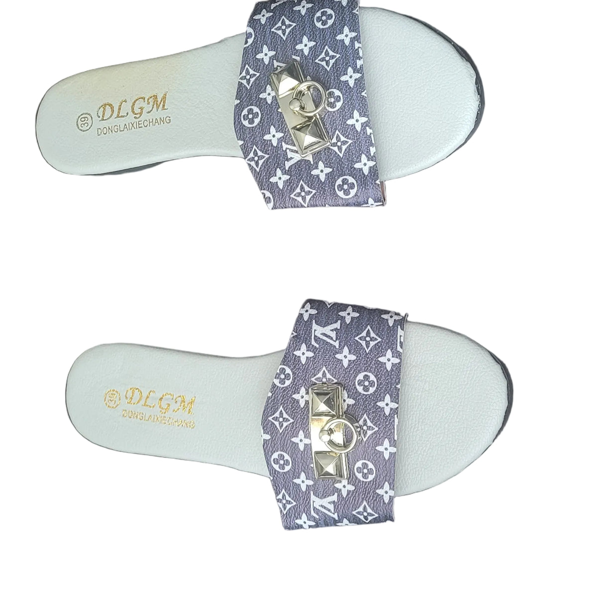 A pair of white slide sandals with purple and gold Louis Vuitton monogram straps, placed on a dark wood floor. The brand 'DCGM' is visible on the footbed.