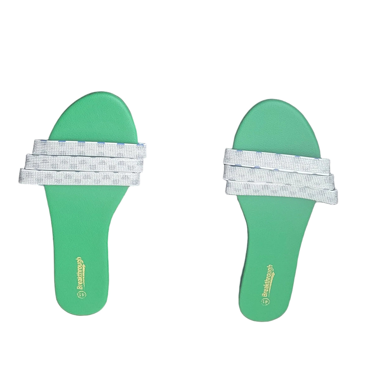 A pair of green slide sandals with white woven straps, laid flat on a dark wood floor.