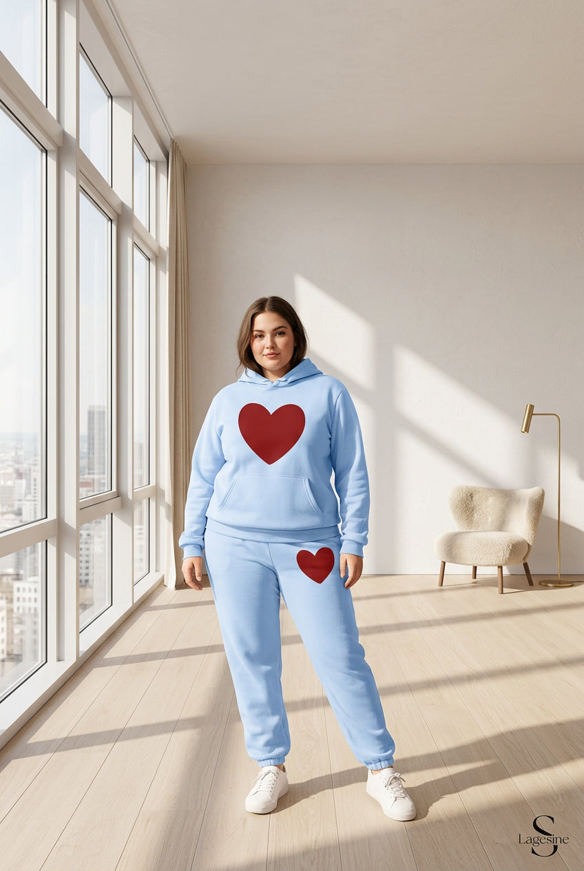 A matching light blue hoodie and jogger pants set with large red heart graphics, shown on a plain white background.
