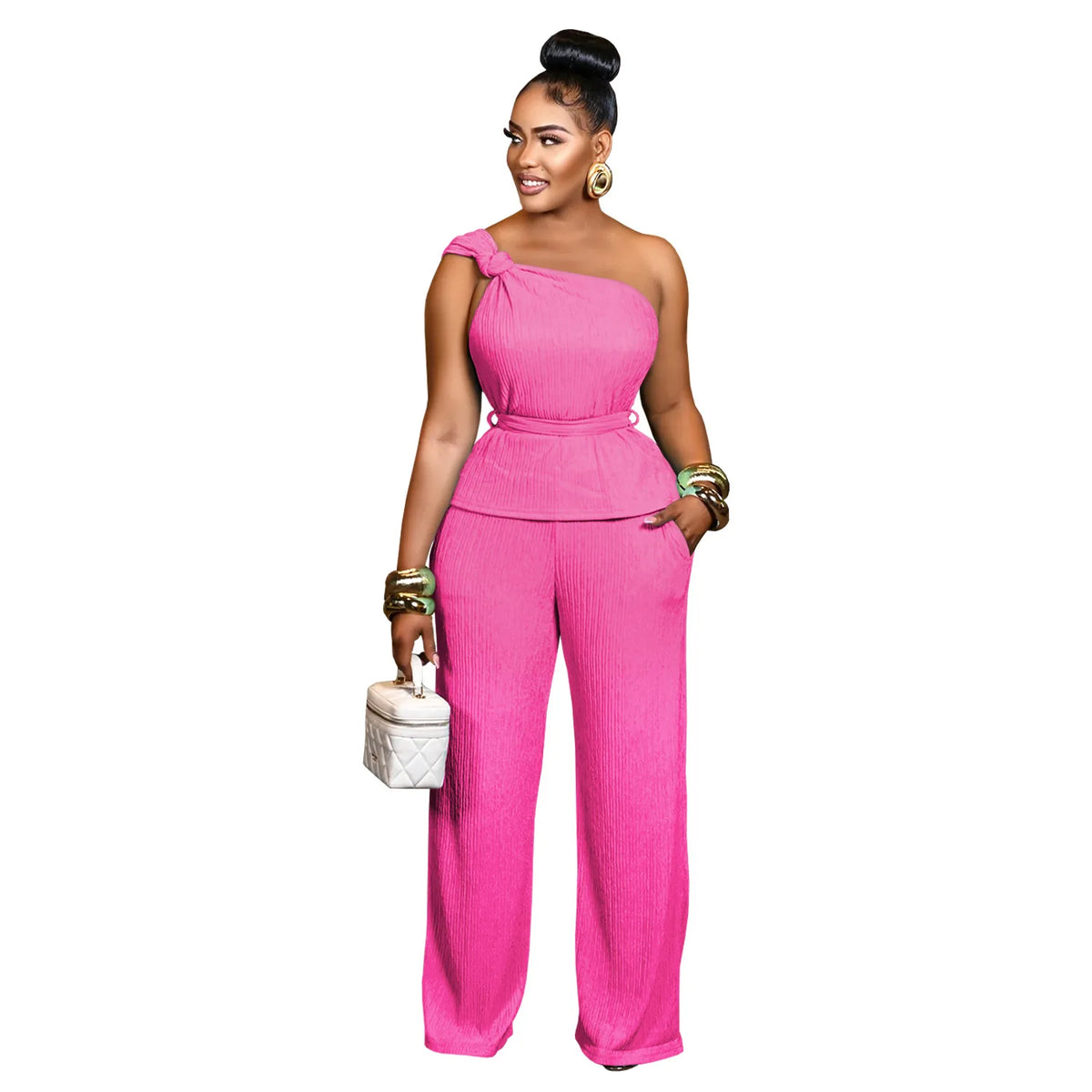 Woman wearing a pink one-shoulder jumpsuit on a white background