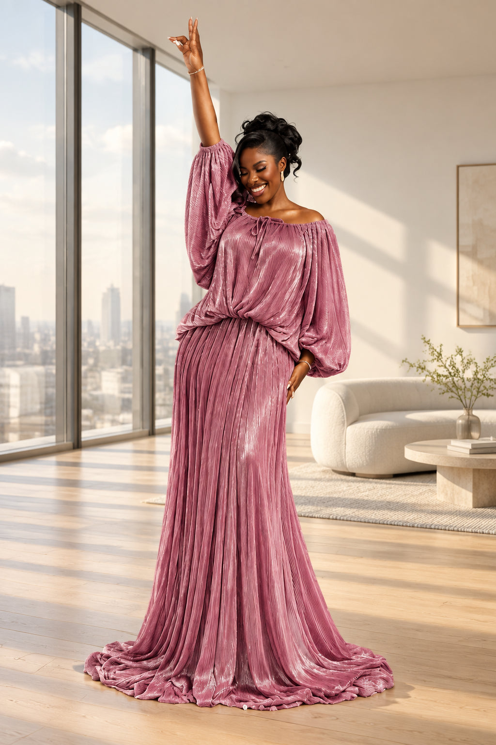 A woman modeling a floor-length off-the-shoulder gown in shimmering dusty pink satin, posed in front of a white draped backdrop with floral arrangements and candles.
