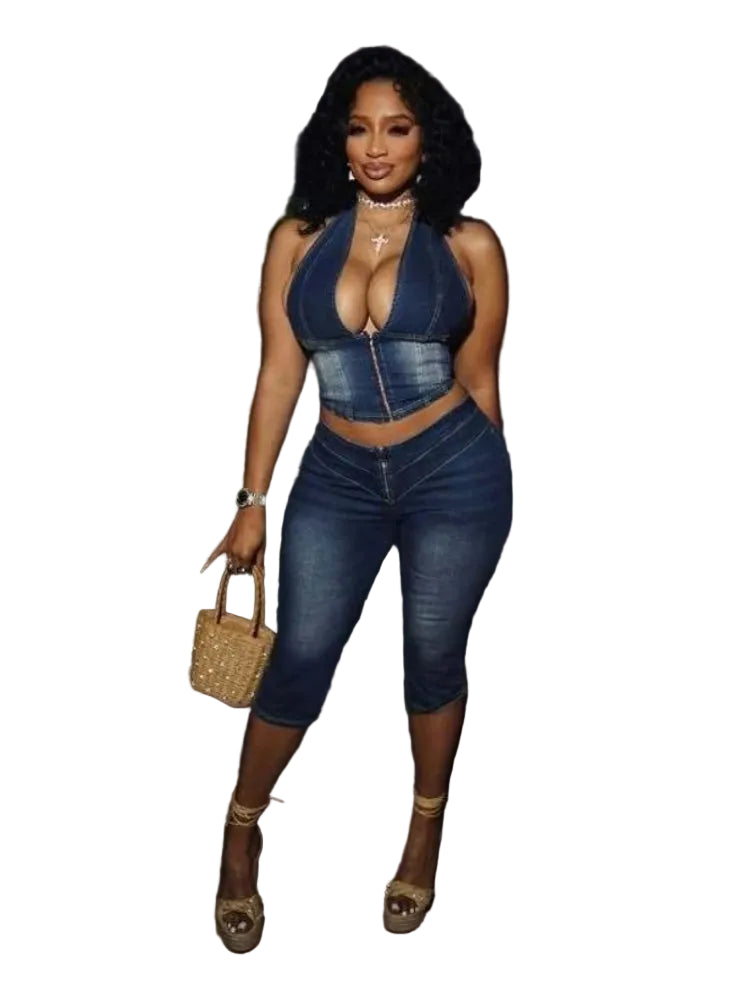 Woman in a denim outfit standing outdoors at night.