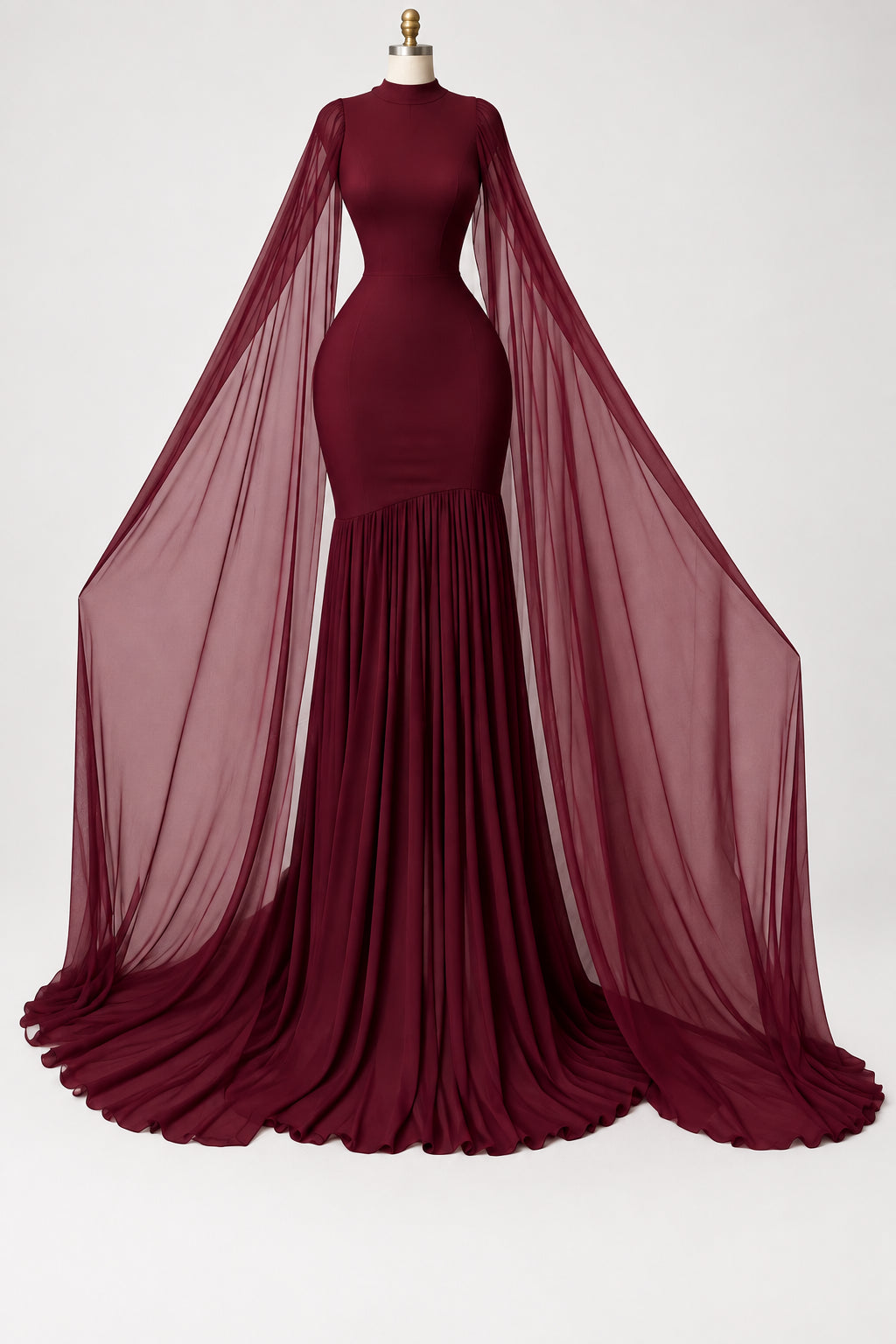 A floor-length burgundy mermaid gown with long sheer draped sleeves displayed on a mannequin in an indoor room with curtains and wood flooring. The brand name CM.