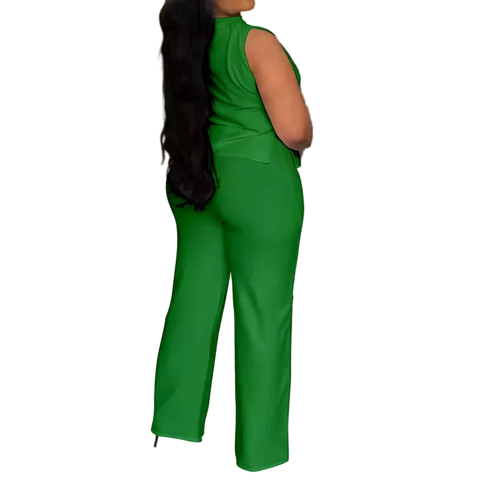 A woman wearing a bright green sleeveless jumpsuit with wide-leg pants, shown from the back in an indoor setting with a tiled floor and decorative wall panels.