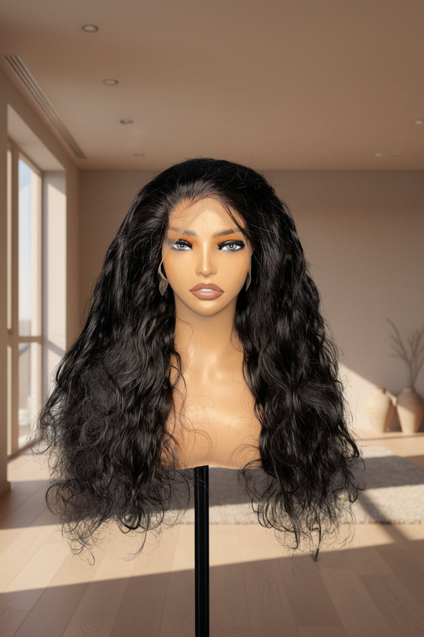 Long, dark wavy wig displayed on a mannequin head and stand against a plain gray studio background.