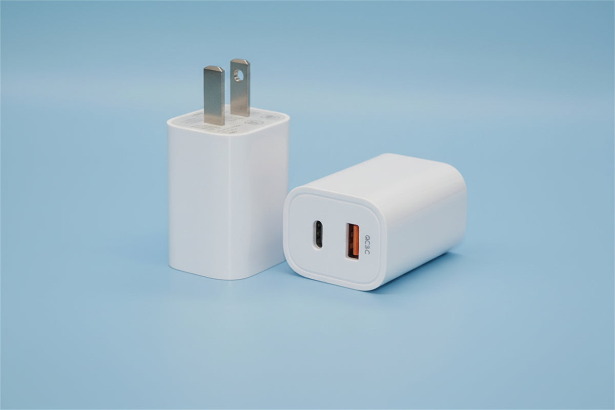A white fast charging wall adapter shown from two angles, displaying its UK two-pin plug on the left and its USB-C and USB-A ports on the right, set against a light blue gradient background.