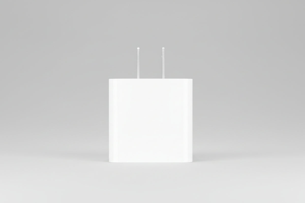 A minimalist white wall charger adapter with two flat silver metal prongs, shown against a solid white background.